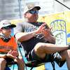 Blake and dad Andrew Middlebrook take in the first weigh-in presentation on opening day of the Bassmasters Elite fishing tournament and festival in Orange Thursday. The event, which includes a carnival, live music nightly, food and vendors, continues through Sunday. Photo made Thursday, April 8, 2021 Kim Brent/The Enterprise
