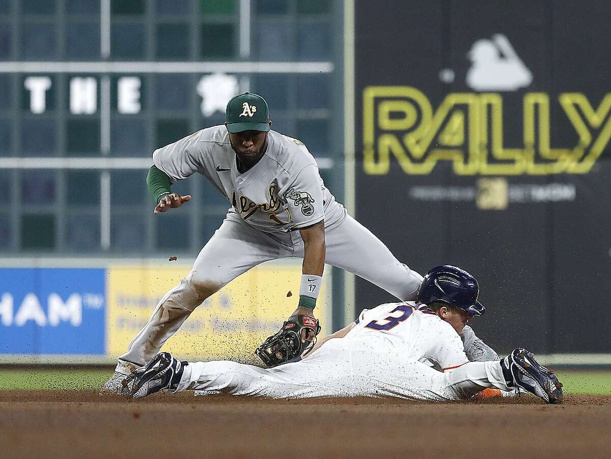 Houston Astros Myles Straw (3) steals second base from Oakland Athletics shortstop Elvis Andrus (17) during the fifth inning of the Astros home opener MLB baseball game at Minute Maid Park, in Houston, Thursday, April 8, 2021.