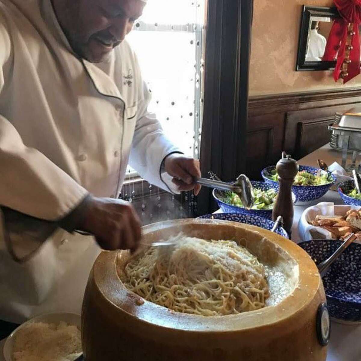 Giuseppe D'Amelio, chef and co-owner of D'Amelio's in Waterbury, prepares spaghetti carbonara tableside in a wheel of fine Parmigiano Reggiano.