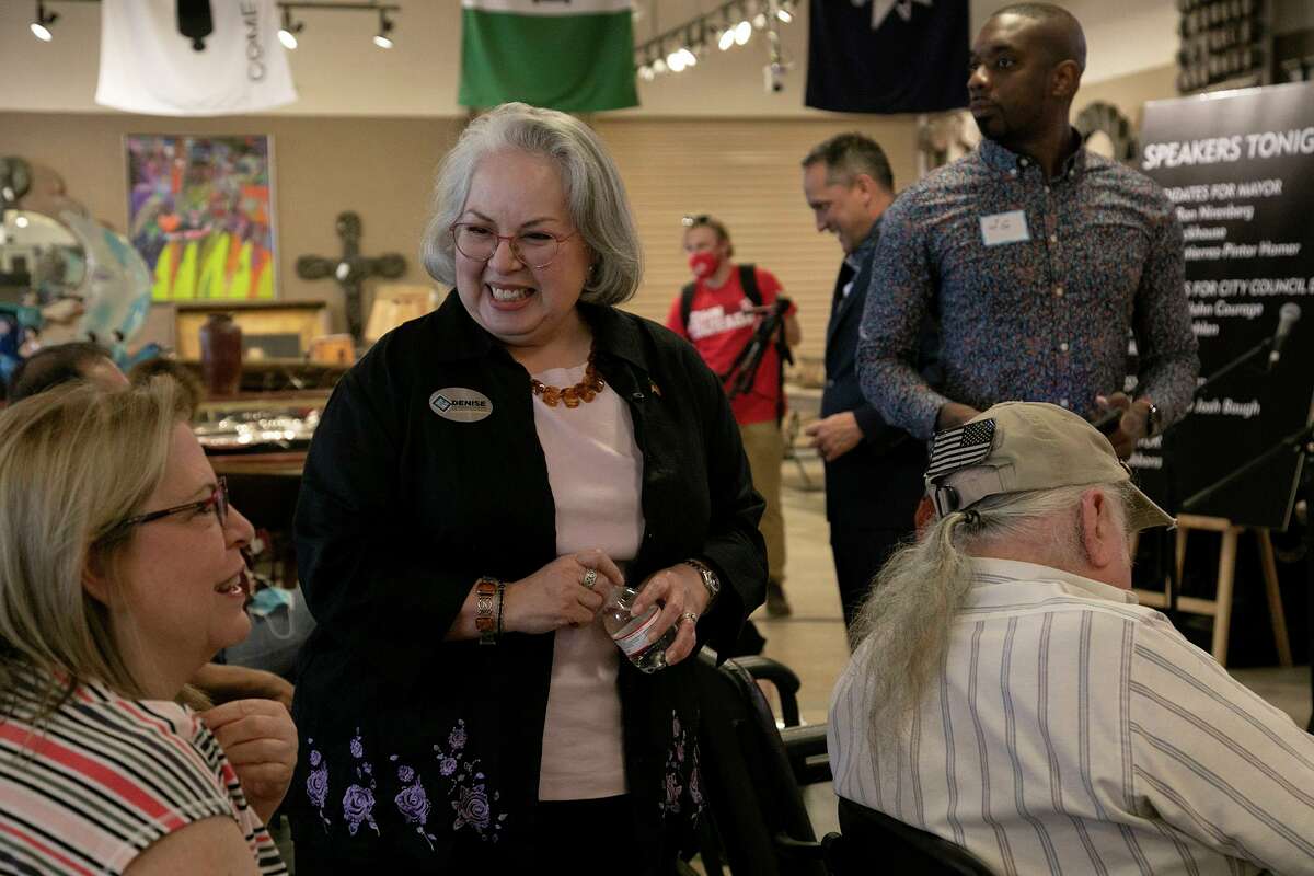 Mayoral candidate Denise Gutierrez-Homer, center, talks with Ellen Boyer, left, before the Greater Harmony Hills Neighborhood Association's Candidate Debate Night at Vogt Auction House in San Antonio on April 8, 2021.