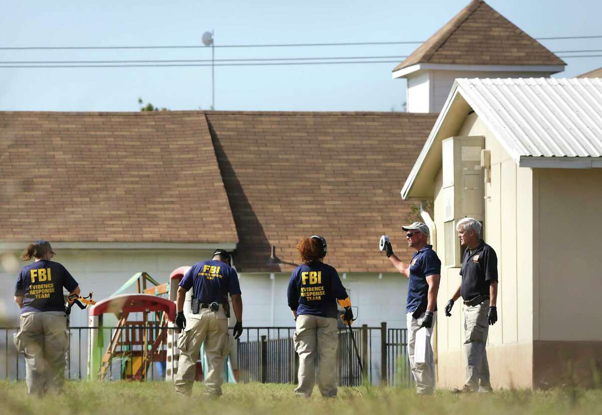 FBI agents use metal detectors to investigate the area near the scene of the mass shooting at First Baptist Church in Sutherland Springs, Texas on Tuesday, November 6, 2017.