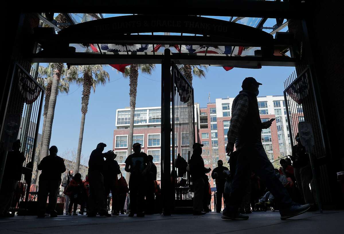 Fans enter the ballpark from Willie Mays Plaza before the San Francisco Giants played the Colorado Rockies at Oracle Park in San Francisco Calif., on Friday, April 9, 2021. After a year confined to watching baseball at home, fans were eager to see a game in-person.