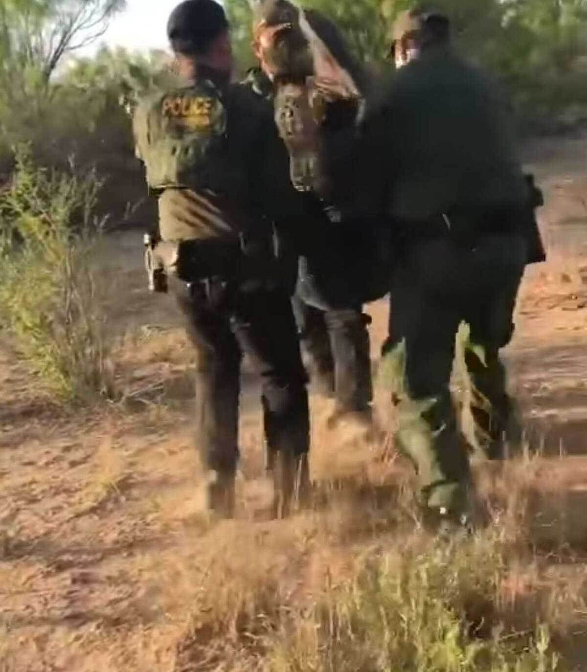 U.S. Border Patrol agents are seen carrying a woman out of the brush. She was determined to be an immigrant illegally present in the country who was suffering from severe dehydration.