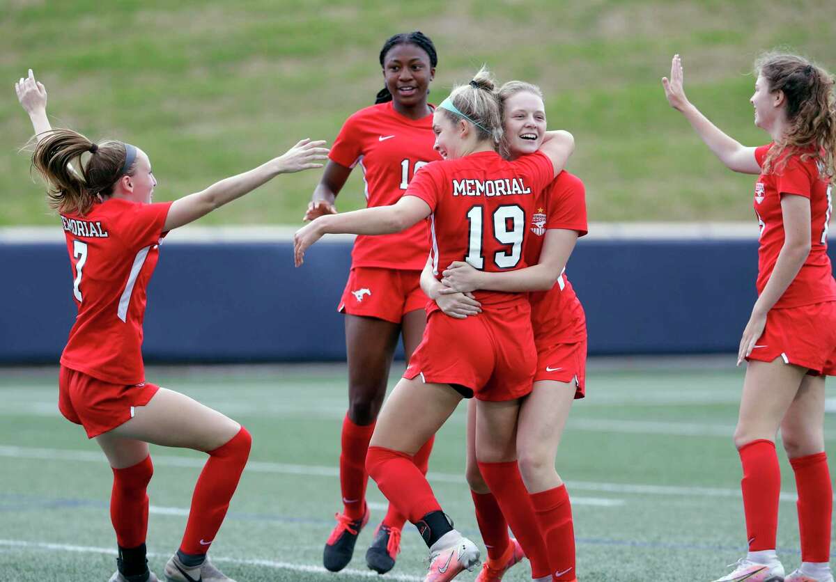 Memorial’s Logan Patterson (19) is swarmed by her teammates after scoring during the first half of their Region 3 championship soccer game against Cy-Fair Friday, Apr. 9, 2021 at Tully Stadium in Houston, TX.