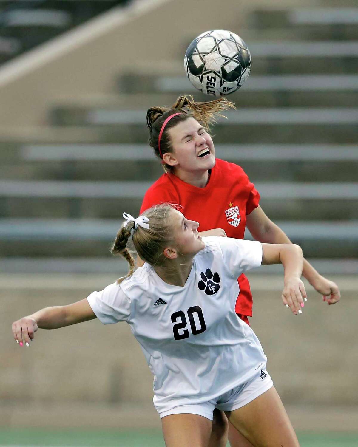 Memorial’s Cara Chaffin, back, wins a header over Cy-Fair’s Ava Drouin (20) during the second half of their Region 3 championship soccer game Friday, Apr. 9, 2021 at Tully Stadium in Houston, TX.