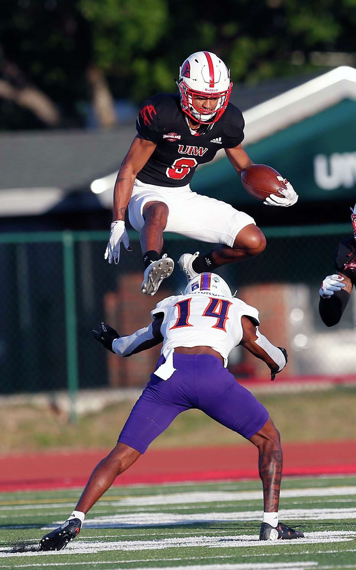 UIW Tre Wolf #9 leaps over Northwestern State Waylon Washington after a reception in first quarter. College Football UIW vs. Northwestern State on Saturday, April 10,2021 at UIW.