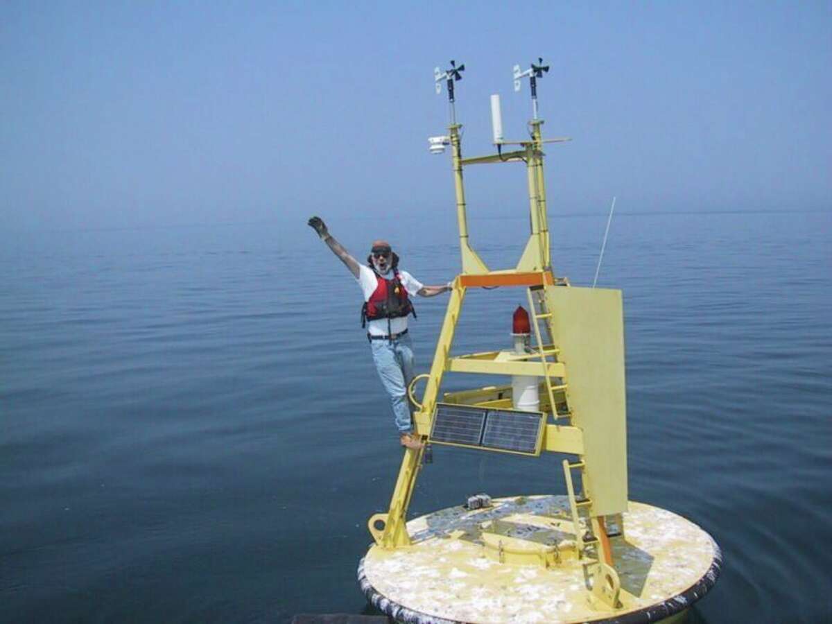 National Oceanic and Atmospheric Administration scientist Mike McCormick, co-author of a study on Lake Michigan's deep water temperatures, stands on an instrument buoy in southern Lake Michigan. (Courtesy photo/Great Lakes Environmental Research Laboratory)