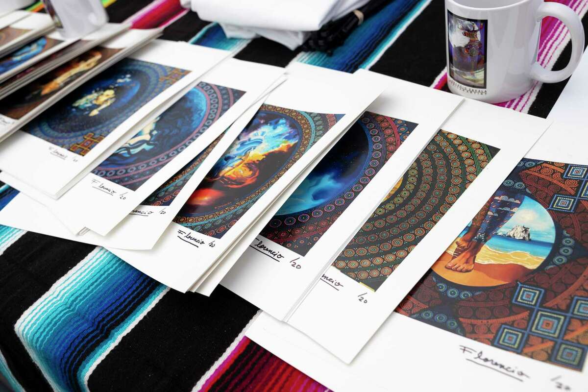 Printed artwork from Florencio Zavala is seen during The Woodlands Waterway Arts Festival.