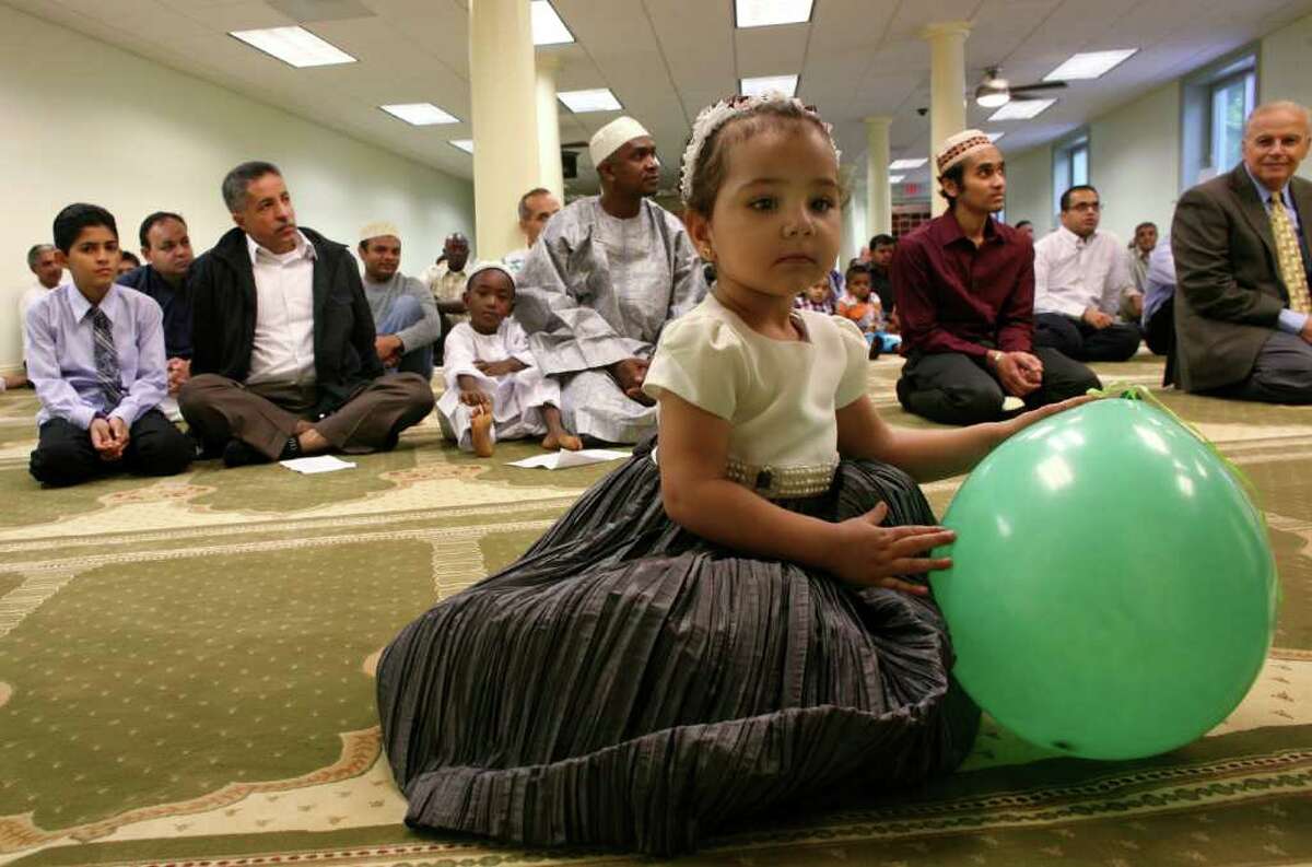 Two year old Mena Kattaria plays with a balloon before the start of prayers at the ICCNY Islamic Center which was celebrating the last day of Ramadan Friday morning.
