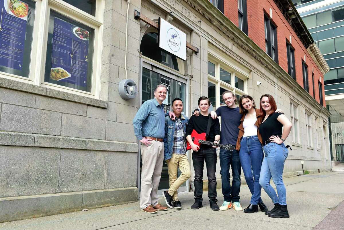 Left to right, Michael Flora and Kyu Tipjak, owners of Blue Orchid, a new pan-Asian restaurant on Court Street in New Haven, with Flora's children, Kevin Flora, Michael Flora, Katie Flora and Mikaela Flora