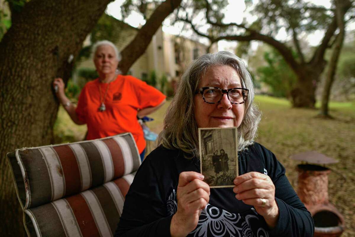 Agnes Rozsa shows a photo taken before the outbreak of World War II of her mother, Klara, and Klara's lost Jewish friend for whom Rozsa was named. Rozsa's friend, Michelle Newman, stands in the background, on Tuesday, Feb. 9, 2021.