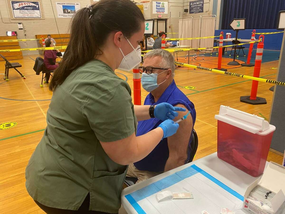 Caitlin Kelley, LPN, administers the COVID-19 vaccine to Christopher Nicholas Coideo of Seymour April 9 at the Naugatuck Valley Health District vaccine clinic at the Seymour Community Center.
