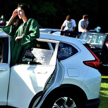 Guilford, Connecticut - Wednesday, June 17, 2020: Senior Rose McDermott of the Guilford H.S. Class of 2020 listens to graduation speakers while in a car during the Covid-19 pandemic induced social-distancing drive-in movie style graduation Wednesday evening at the Guilford Fairgrounds.