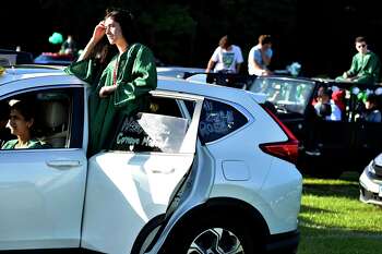 Guilford, Connecticut - Wednesday, June 17, 2020: Senior Rose McDermott of the Guilford H.S. Class of 2020 listens to graduation speakers while in a car during the Covid-19 pandemic induced social-distancing drive-in movie style graduation Wednesday evening at the Guilford Fairgrounds.
