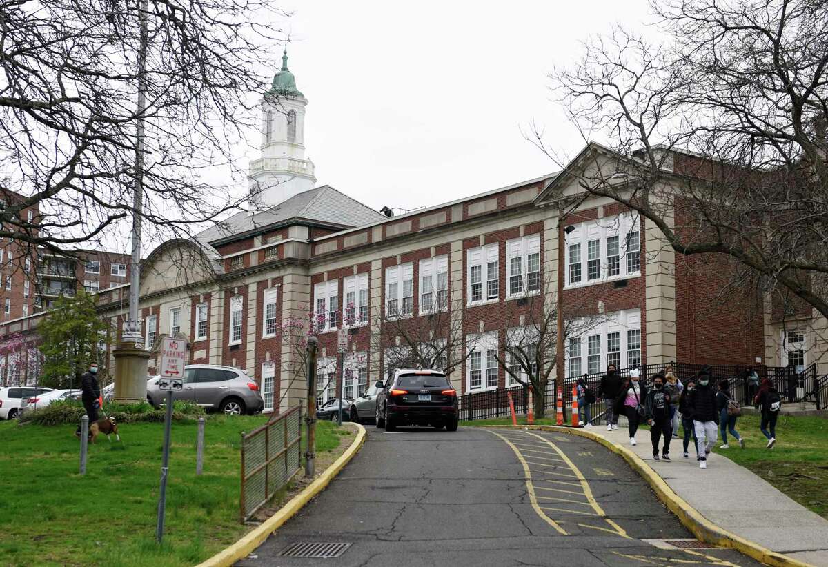 Students are dismissed at Stamford High School in Stamford, Conn. Monday, April 12, 2021.