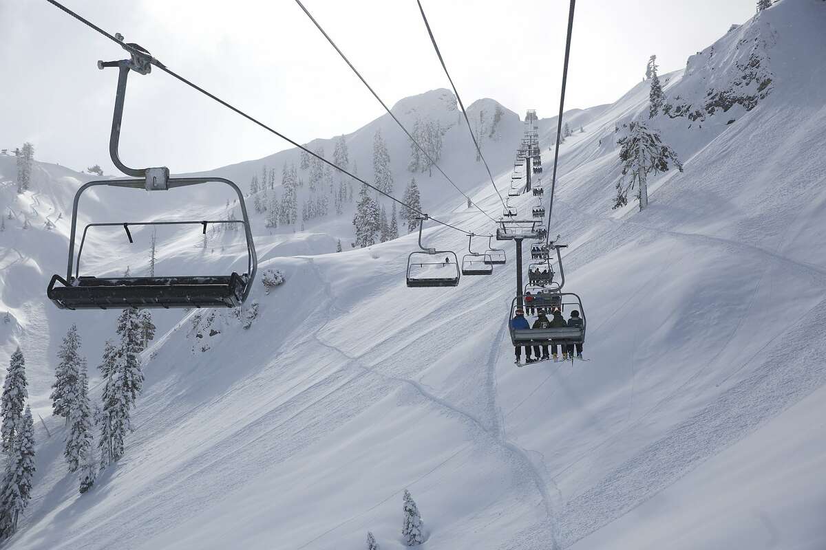 Skiers on the KT-22 chairlift at Squaw Valley in North Lake Tahoe. A new gondola connecting to Alpine Meadows via the backside of Squaw’s famed KT-22 mountain, is to be built at the resorts.