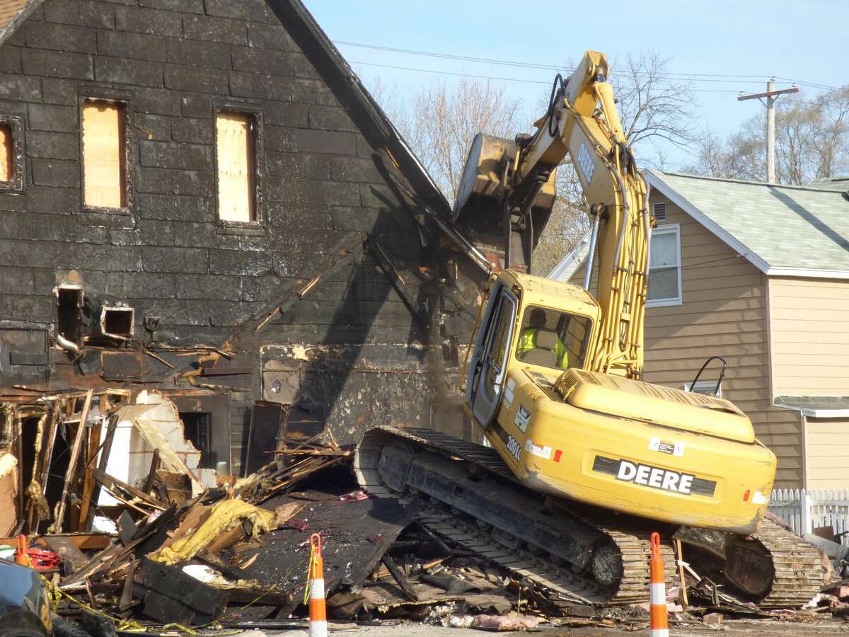 The Hi-Way Inn in Manistee's Maxwelltown neighborhood was demolished Monday following a fire last August.