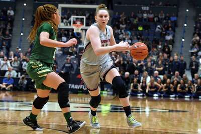 Connecticut's Anna Makurat, right, dribbles against South Florida's Elena Tsineke in the second half of an NCAA college basketball game, Monday, March 2, 2020, in Hartford, Conn. (AP Photo/Jessica Hill)