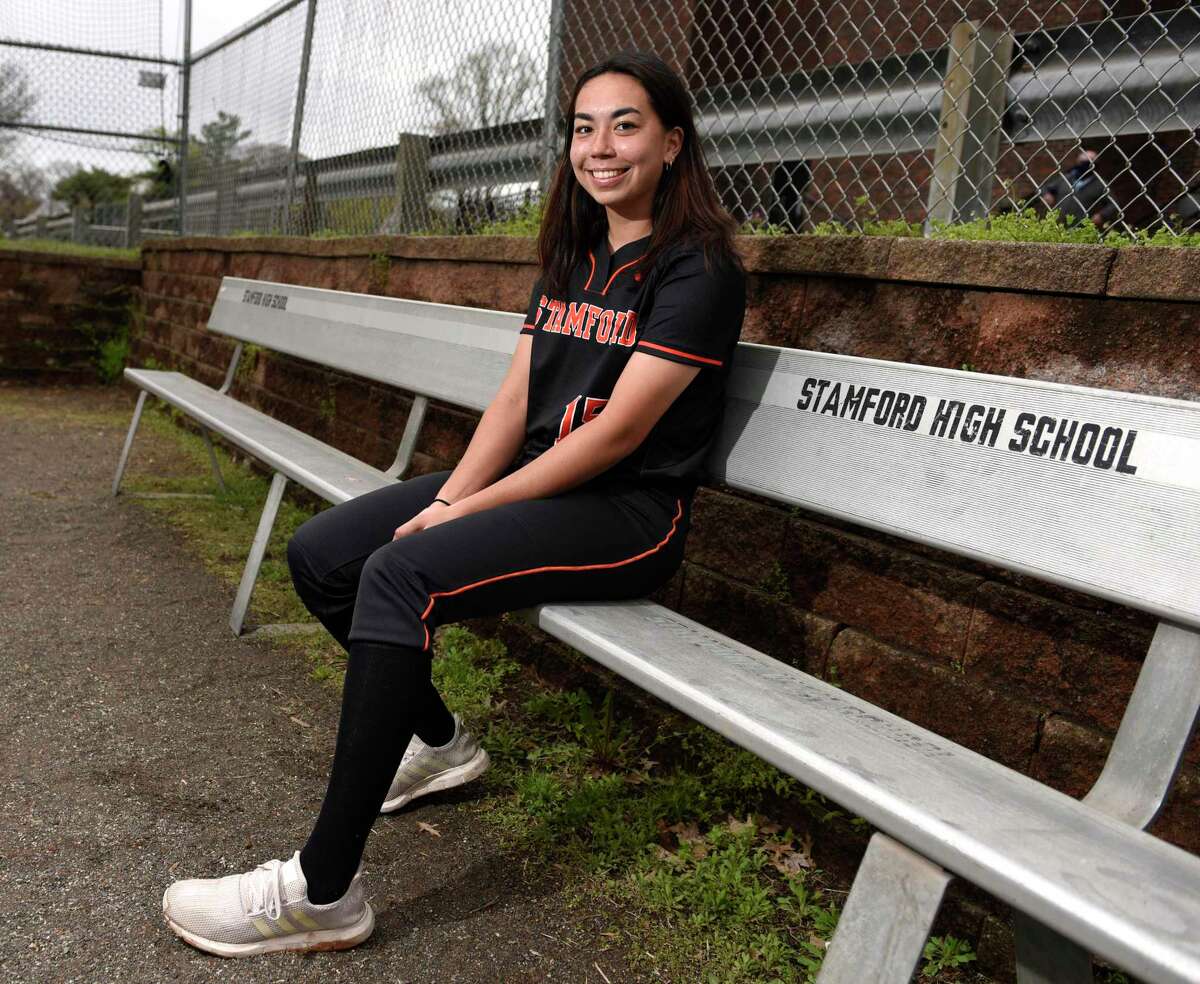 Pitcher Kim Saunders, a senior, poses on the softball field at Stamford High School in Stamford, Conn. Monday, April 12, 2021. Saunders recently committed to play college softball at Bentley University, a Division II school in Waltham, Mass.