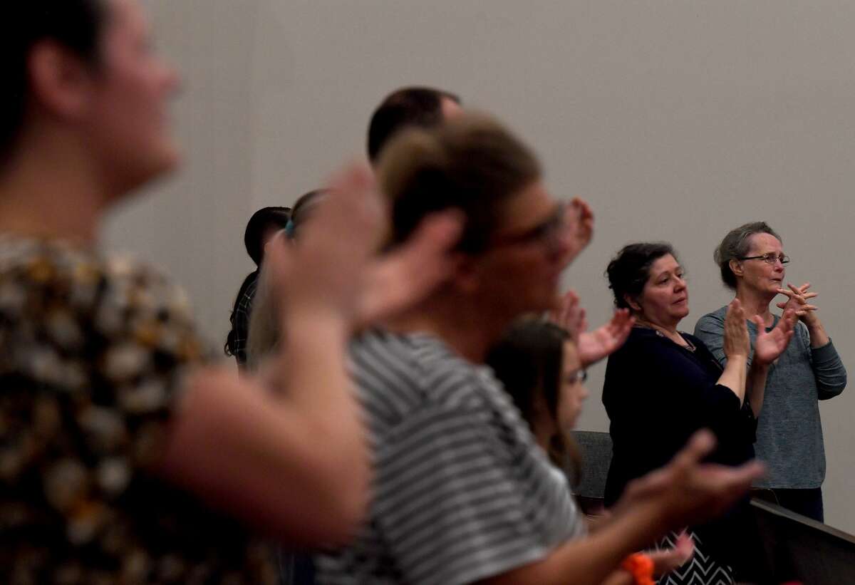 Attendees join in a prayer vigil for Orange County Sheriff's officers Dru Crochet and Scott Barnes and Orange City Policeman Howard DeVault at Eastgate United Pentecostal Church in Vidor Monday. The three officers are battling serious illesses, prompting the community to rally together in prayers and support. The event included altar calls for any in need of healing at its finale. Photo made Monday, April 12, 2021 Kim Brent/The Enterprise