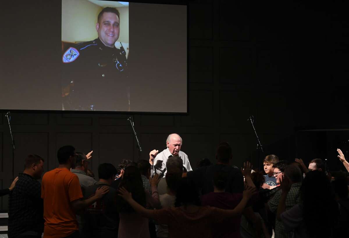 Jim Pickering leads attendees as they join in a prayer vigil for Orange County Sheriff's officer Dru Crochet at Eastgate United Pentecostal Church in Vidor Monday. The three officers are battling serious illesses, prompting the community to rally together in prayers and support. The event included altar calls for any in need of healing at its finale. Photo made Monday, April 12, 2021 Kim Brent/The Enterprise