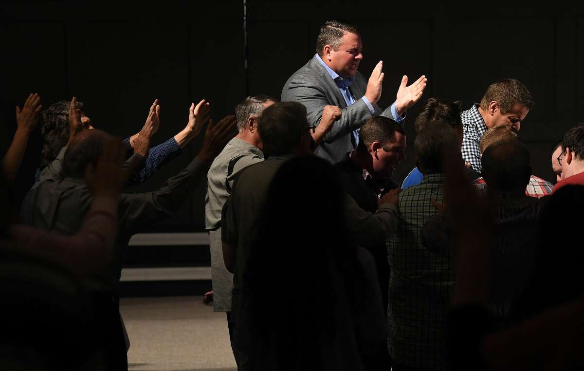 Attendees join in a prayer vigil for Orange County Sheriff's officers Dru Crochet and Scott Barnes and Orange City Policeman Howard DeVault at Eastgate United Pentecostal Church in Vidor Monday. The three officers are battling serious illesses, prompting the community to rally together in prayers and support. Photo made Monday, April 12, 2021 Kim Brent/The Enterprise