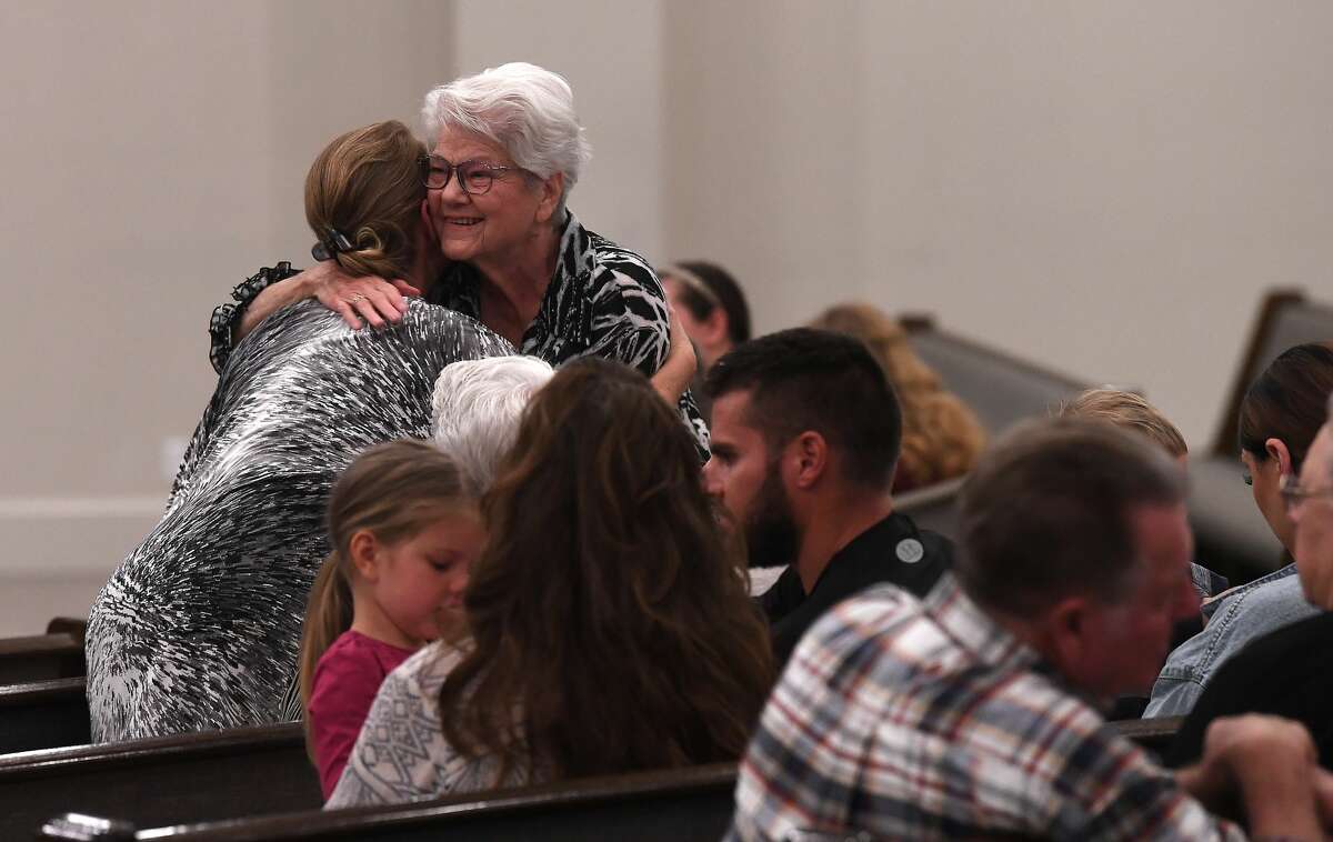 Attendees greet one another as they arrive for a prayer vigil for Orange County Sheriff's officers Dru Crochet and Scott Barnes and Orange City Policeman Howard DeVault at Eastgate United Pentecostal Church in Vidor Monday. The three officers are battling serious illesses, prompting the community to rally together in prayers and support. Photo made Monday, April 12, 2021 Kim Brent/The Enterprise