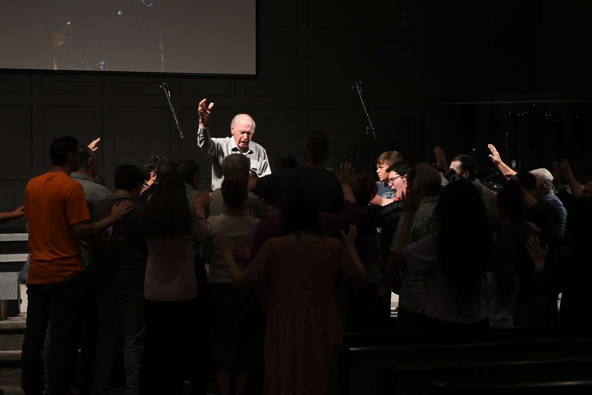 Jim Pickering leads attendees as they join in a prayer vigil for Orange County Sheriff's officer Dru Crochet at Eastgate United Pentecostal Church in Vidor Monday. The three officers are battling serious illesses, prompting the community to rally together in prayers and support. The event included altar calls for any in need of healing at its finale. Photo made Monday, April 12, 2021 Kim Brent/The Enterprise
