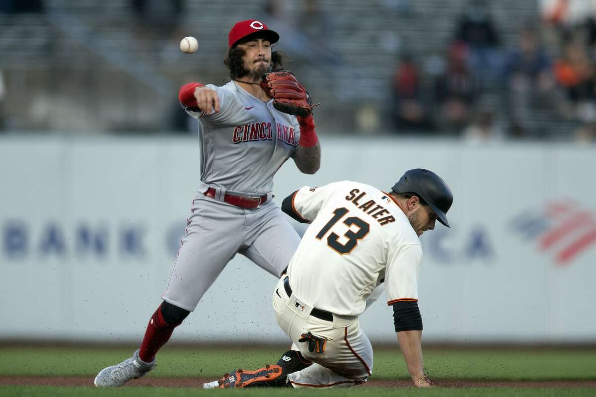 Cincinnati Reds second baseman Jonathan India (6) throws over San Francisco Giants' Austin Slater (13) too late to double up Donovan Solano at first during the first inning of a baseball game, Monday, April 12, 2021, in San Francisco, Calif.