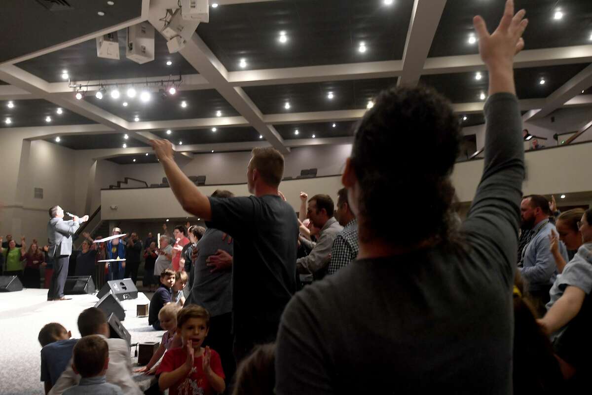 Attendees join in a final open prayer call during a vigil for Orange County Sheriff's officers Dru Crochet and Scott Barnes and Orange City Policeman Howard DeVault at Eastgate United Pentecostal Church in Vidor Monday. The three officers are battling serious illesses, prompting the community to rally together in prayers and support. The event included altar calls for any in need of healing at its finale. Photo made Monday, April 12, 2021 Kim Brent/The Enterprise