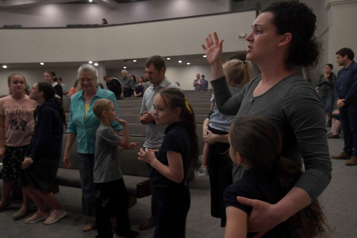 Attendees join in a final open prayer call during a vigil for Orange County Sheriff's officers Dru Crochet and Scott Barnes and Orange City Policeman Howard DeVault at Eastgate United Pentecostal Church in Vidor Monday. The three officers are battling serious illesses, prompting the community to rally together in prayers and support. The event included altar calls for any in need of healing at its finale. Photo made Monday, April 12, 2021 Kim Brent/The Enterprise