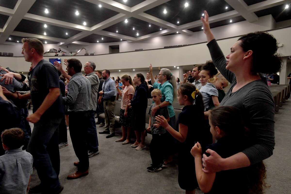 Attendees join in a final open prayer call during a vigil for Orange County Sheriff's officers Dru Crochet and Scott Barnes and Orange City Policeman Howard DeVault at Eastgate United Pentecostal Church in Vidor Monday. The three officers are battling serious illesses, prompting the community to rally together in prayers and support. The event included altar calls for any in need of healing at its finale. Photo made Monday, April 12, 2021 Kim Brent/The Enterprise