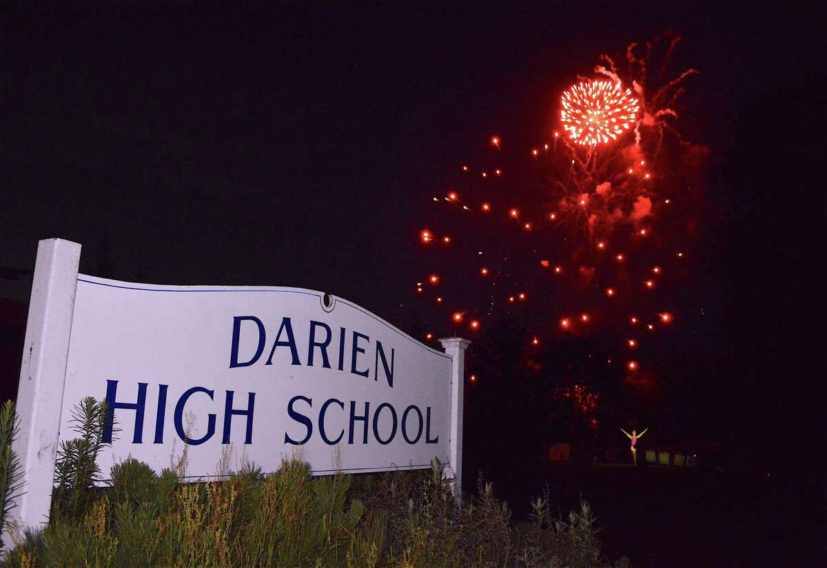 Skyrockets burst over the school at the annual fireworks celebration at Darien High School, Sunday, July 2, 2017, in Darien, Conn.