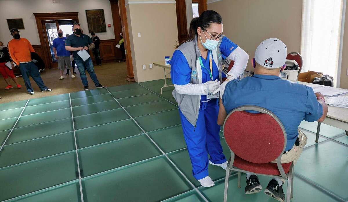 Griffin Hospital nurse Carrie Cotto administers the Johnson & Johnson COVID-19 vaccine to Reinaldo Vazquez, of Meriden, Conn., during a clinic at the Augusta Curtis Cultural Center on Wednesday, April 7, 2021. (Dave Zajac /Record-Journal via AP)