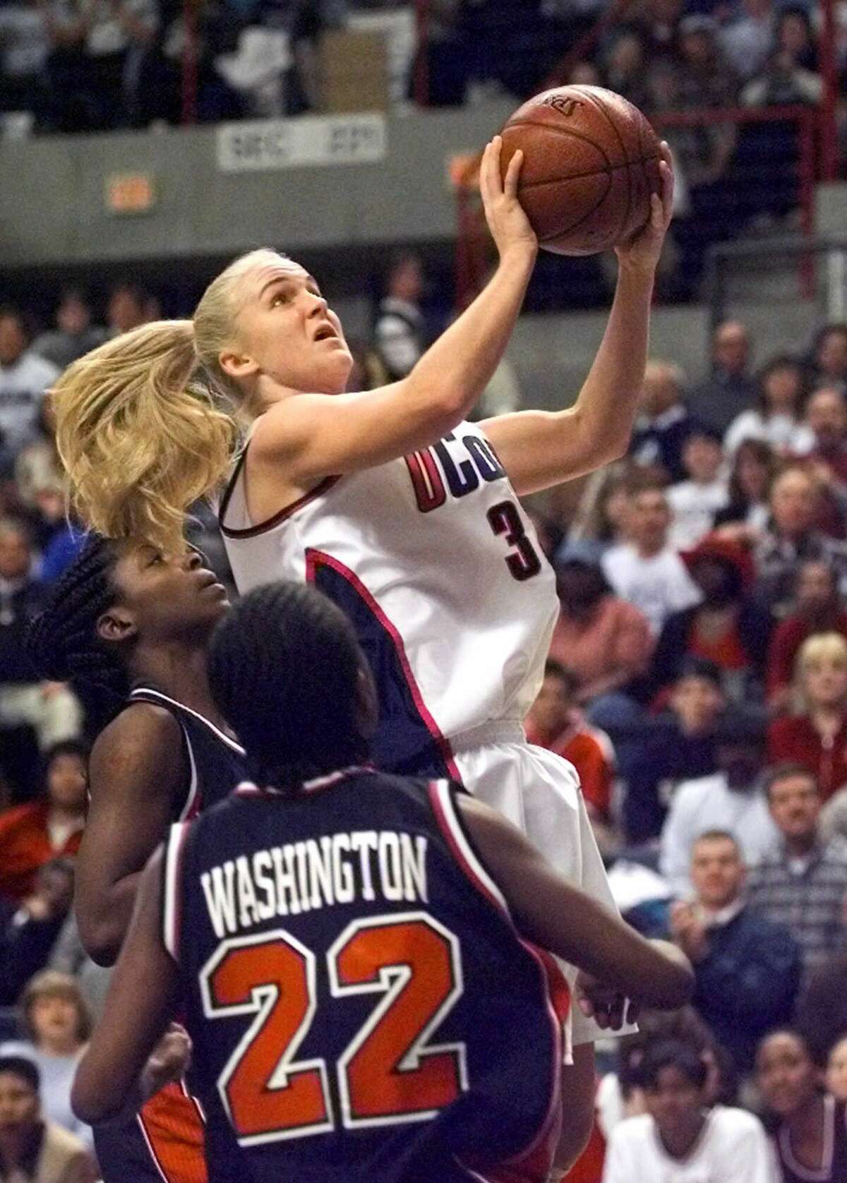 Connecticut's Shea Ralph goes up past Rutgers Karlita Washington and Linda Miles for a shot in the first half of the Connecticut-Rutgers championship round game at the 2000 Big East Championship at Storrs, Conn., Tuesday, March 7, 2000. (AP Photo/Bob Child)