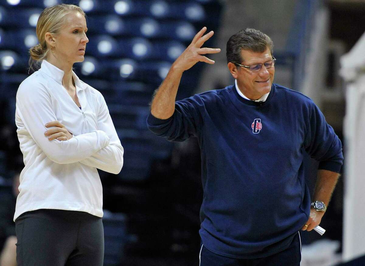 Connecticut coach Geno Auriemma, right, gestures as assistant coach Shea Ralph watches practice before the NCAA college basketball team's media day in Storrs, Conn., Tuesday, Oct. 16, 2012. (AP Photo/Jessica Hill)