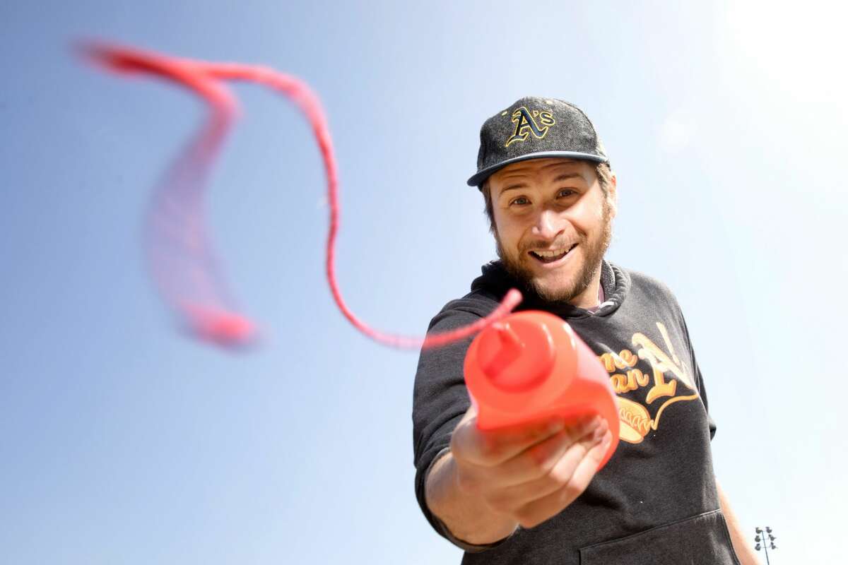 Hal Gordon shoots out his famous trick ketchup bottle (it's actually a string, not real ketchup). Gordon is an Oakland A's hot dog vendor who's also getting his PhD at UC Berkeley.