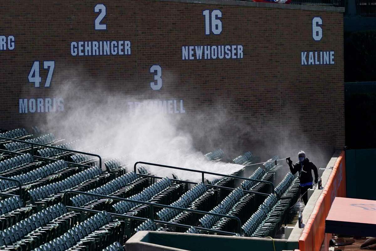 Tyrone Sparks power washes the left field seats at Comerica Park, Wednesday, March 31, 2021, in Detroit. (AP Photo/Carlos Osorio)