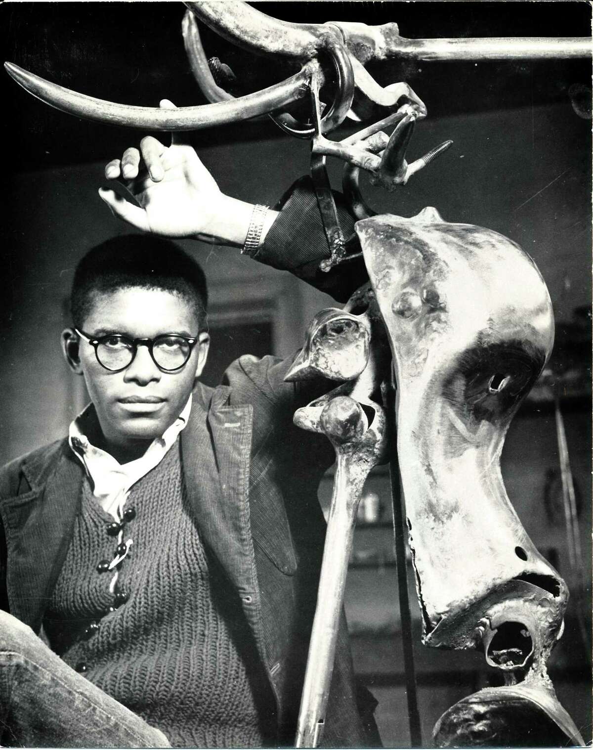 This photo by noted photographer and textile artist Martha Mood shows Richard Hunt posing with a work he titled “Longhorn” at the Mills Race Studio in about 1960, decades after sculptor Gutzon Borglum used the studio in the 1920s and '30 to develop prototypes for Mount Rushmore. Hunt, then in his mid-20s, went on to become a prolific sculptor who broke many social and cultural barriers as a Black artist. He said he was embraced by San Antonio's arts community while serving as an Army medic at Fort Sam Houston.