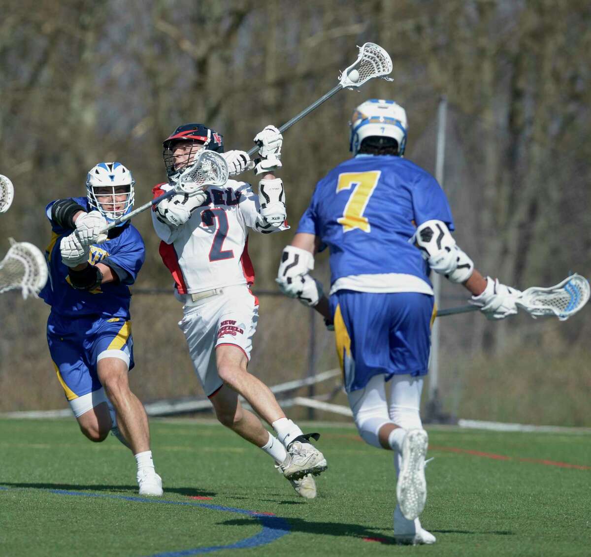 New Fairfield's Nathan Alviti (2) shoots while being defended by Brookfield's Ryan Sanborn (19) in the boys lacrosse game between Brookfield and New Fairfield high schools. Tuesday, April 13, 2021, at New Fairfield High School, New Fairfield, Conn.
