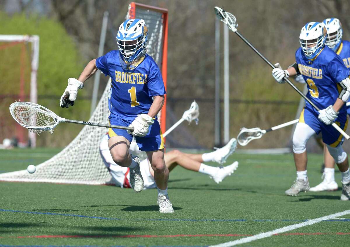 Brookfield goalie Nicholas Schilling (1) chases down a loose ball away from the goal in the boys lacrosse game between Brookfield and New Fairfield high schools. Tuesday, April 13, 2021, at New Fairfield High School, New Fairfield, Conn.