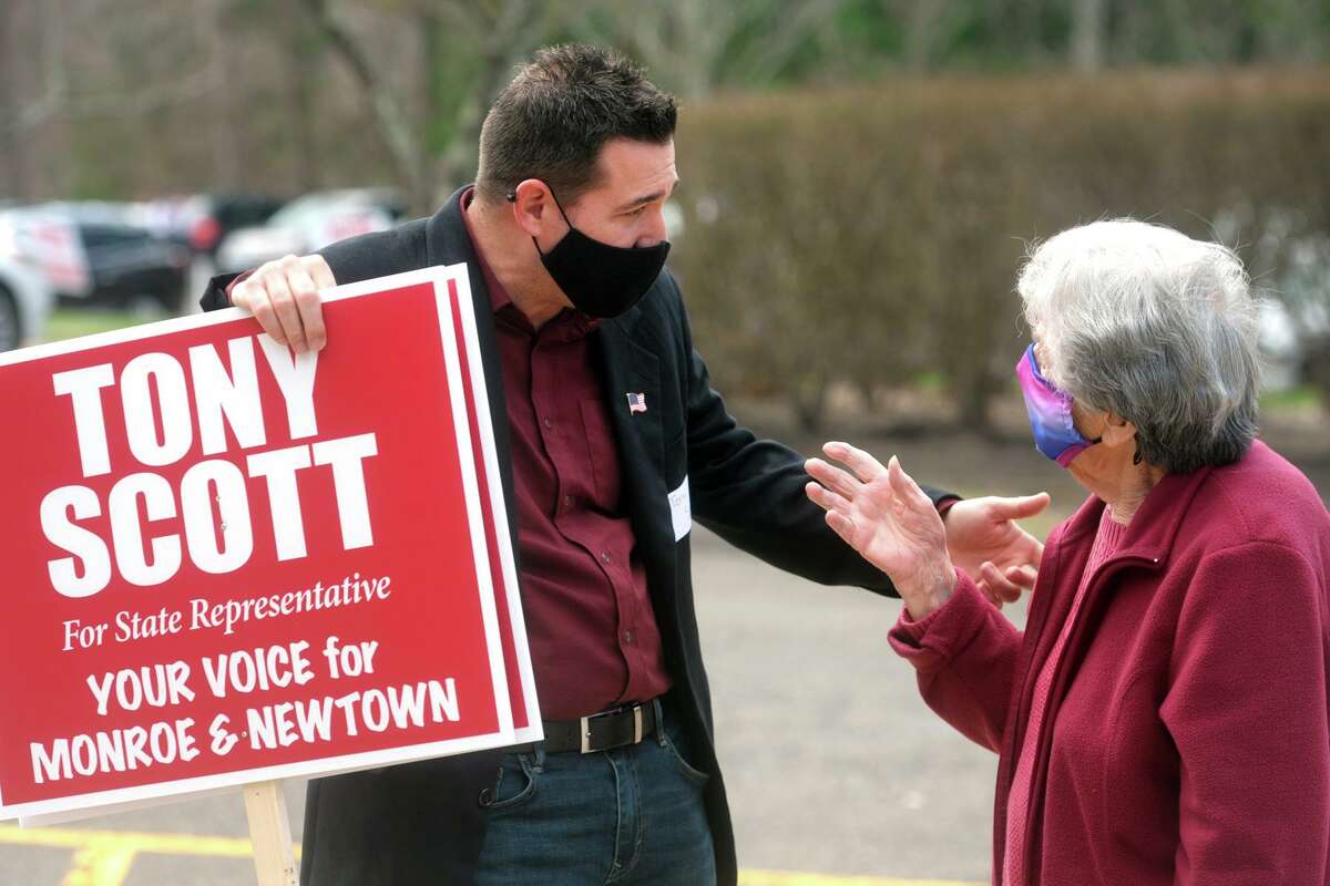 Republican candidate Tony Scott speaks with Georgeann McKiernan as she arrives to vote in Tuesday’s special election for the 112th House seat at Masuk High School, in Monroe, Conn. April 13, 2021.