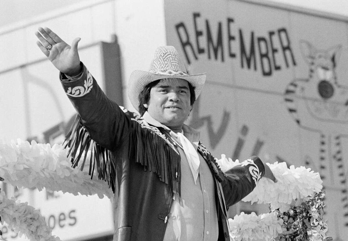 Looking more like a cowboy than a baseball player, Los Angeles Dodgers' pitching ace Fernando Valenzuela waves from atop the Grand Marshal's float during this year's Christmas parade in downtown Los Angeles on Nov. 23, 1981. (AP Photo/Thanh My Huynh)