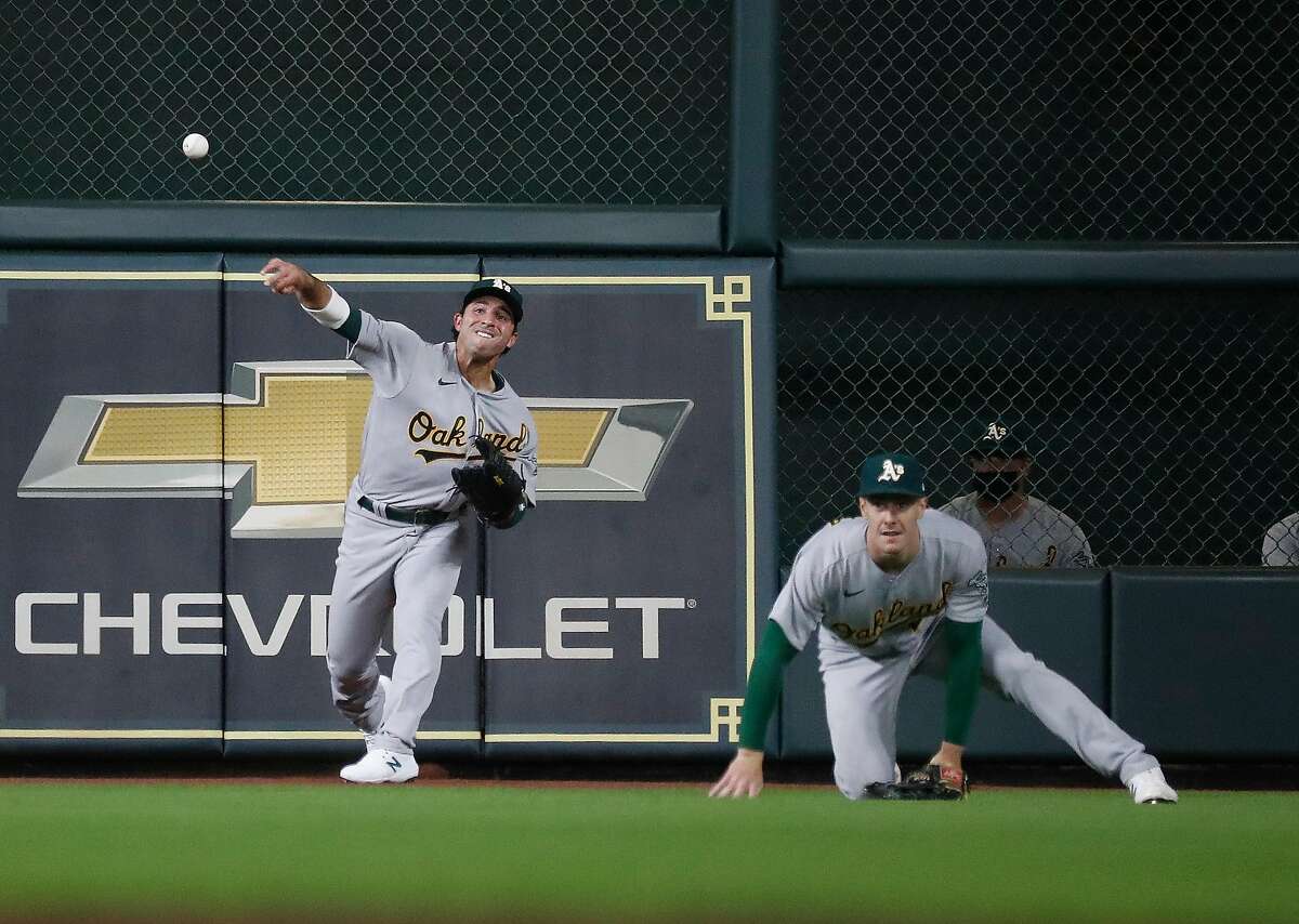 Oakland Athletics Ramon Laureano (22) makes a throw on Houston Astros Yordan Alvarez’s double during the fourth inning of the Astros home opener MLB baseball game at Minute Maid Park, in Houston, Thursday, April 8, 2021.