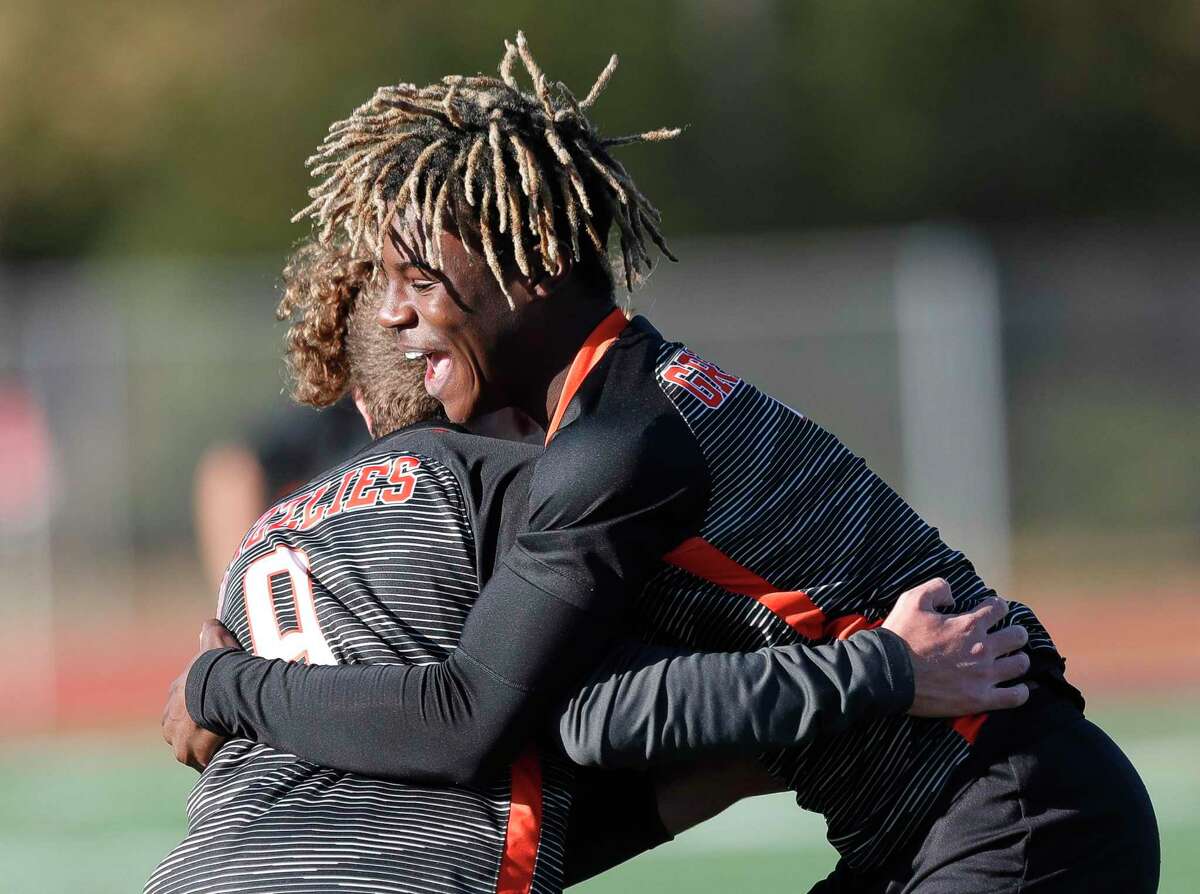 Grand Oaks’ Ramiere Johnson, right, hugs Omar Younes after Younes’ goal in the first period of a soccer match during the Humble ISD Bayou City Classic at Atascocita High School, Friday, Jan. 15, 2021, in Atascocita.