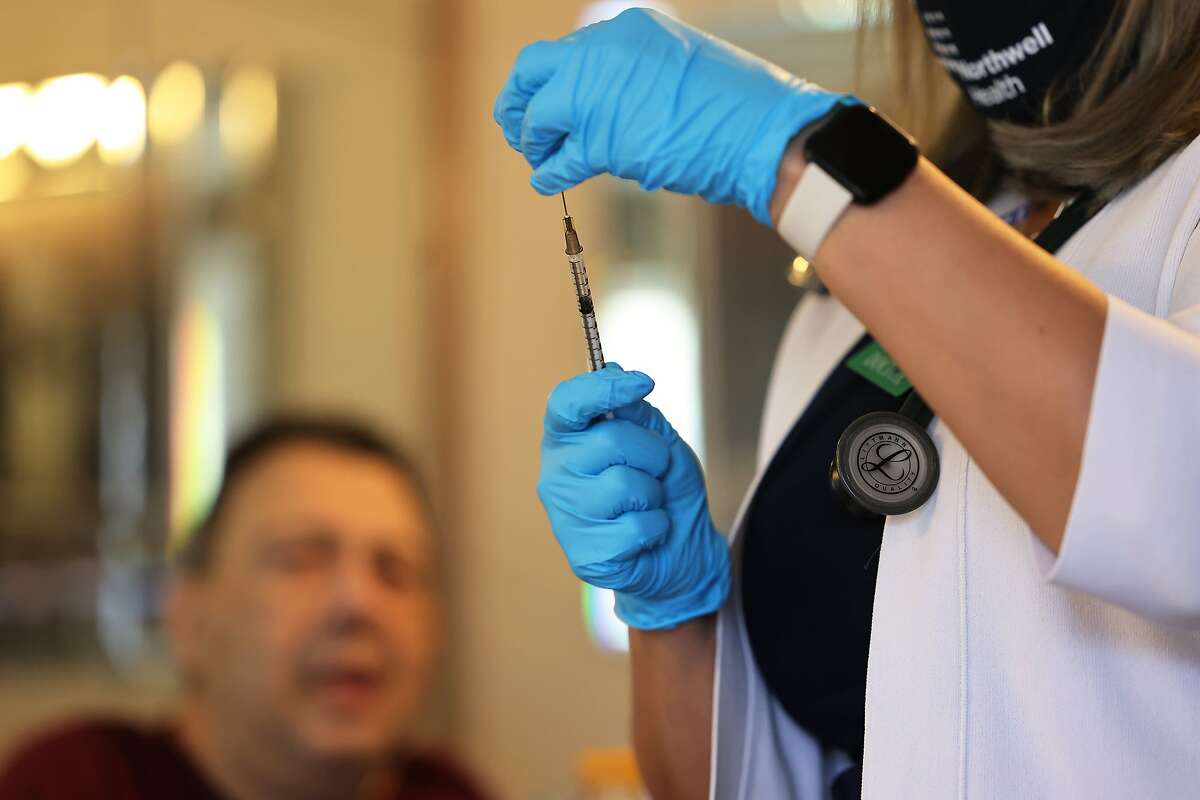 NEW YORK, NEW YORK - APRIL 07: Zenobia Brown, MD, of the Northwell Health house calls program prepares a dose of the Johnson & Johnson coronavirus (COVID-19) vaccine in the Ozone Park neighborhood of Queens borough on April 07, 2021 in New York City. NYC continues to have a 6.55 percent coronavirus (COVID-19) cases on a seven-day rolling average as the city continues to ramp up vaccinations. The city last week set a record of 524,520 coronavirus (COVID-19) vaccinations. (Photo by Michael M. Santiago/Getty Images)