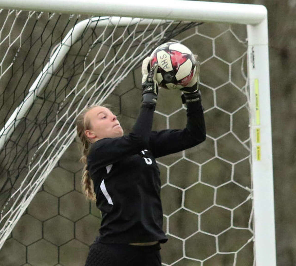 Alton goalie Addison Miller makes a save during a 2019 game. Miller, now a senior, is one of three senior captains on the AHS team this season. The Redbirds, like all Illinois high school girls soccer teams, are returning this week for the first time since 2019 after the 2020 season was cancelled because of the pandemic.