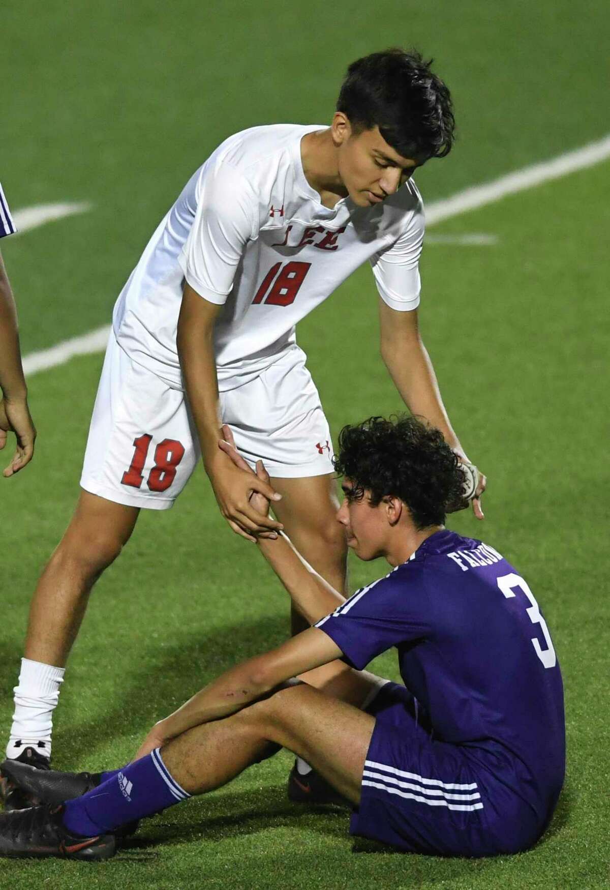Alldair Ellias of LEE comforts Jose Bejarano of Jersey Village after LEE's 2-0 victory in the Class 6A state semifinal in Georgetown on Tuesday, April 13, 2021.