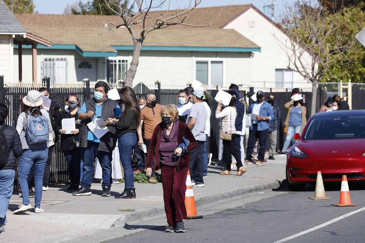 A line at the Iglesia Fuente De Salvacion Church as the Community Clinic Consortium in Contra Costa and Solano Counties host a free vaccination clinic on Saturday, April 10, 2021 in San Pablo, Calif.