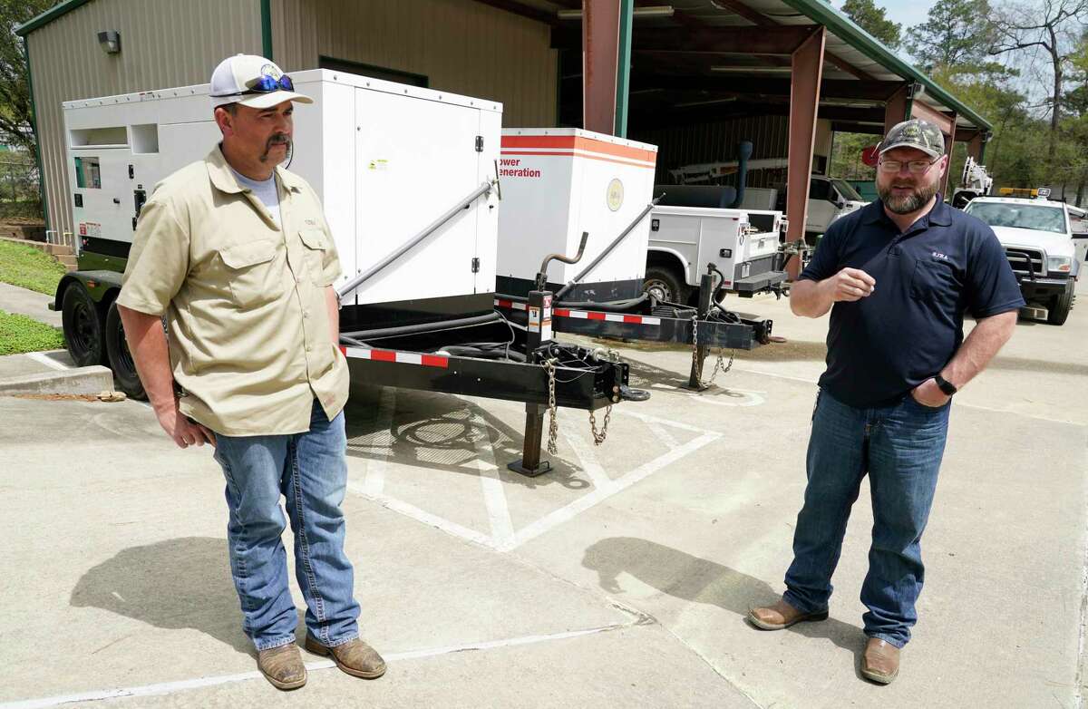 Jacob Everett, chief maintenance technician, left, and Jason Williams, operation manager, right, talk near the portable generators at the San Jacinto River Authority Wastewater Treatment Plant No. 1 Wednesday, March 17, 2021 in The Woodlands.